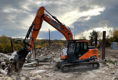 Digger breaking up rubble